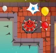 Tack Sprayer shooting out 16 tacks per shot. Some tacks have hit bloons.