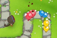 Flash Bomb Ninja Monkey stunning a group of bloons