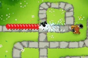 Spike-o-pult hurling a spiked ball that pierces many bloons, and the operator reloading the Spike-o-pult