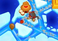 A Ninja Monkey throwing a flash bomb at a Ceramic Bloon in Frozen Over