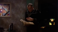 Michael Garibaldi reading the Book of G'Quan