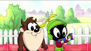 Baby Marvin fixes the toy rocket using his hands and returns it back to Baby Bugs, to his awe.
