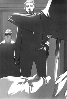  et Manfred regardent  appuyer un coupe papier contre la jugulaire de Hong Chi-Mei.