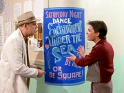  and  looking at the poster for the dance