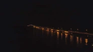 115253005-aerial-view-lighted-bridge-at-night-with-highways-and-cars-suspension-bridge-over-madura-strait-with