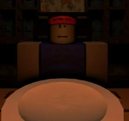 Ivan sitting down at the family reunion, talking to his Mom and Andrew.