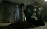 Sherlock examining Jennifer Wilson's body.