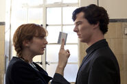 Kitty Riley giving Sherlock her card.