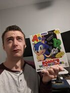 mystman12 holding the game Sonic's Schoolhouse.