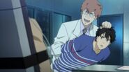 Abraham holds Eiji to Shorter's face