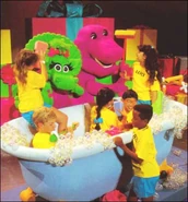 Barney, Baby Bop, and the Backyard Gang playing in the bathtub