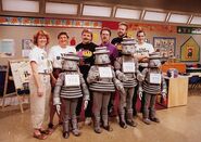 Jess and four other crew members with the children's cast of this episode, "Everyone Is Special" dressed as robots.