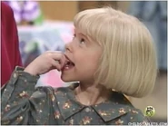 Linda wiggling her tooth.