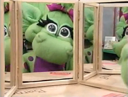 Baby Bop looking at herself in the mirror