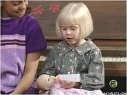 Linda holding a baby doll.