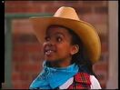 Keesha wearing a cowgirl hat in Barney's Adventure Bus.