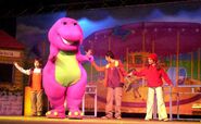 Barney and the kids on stage.