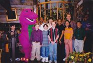 Barney with the original cast members of Barney & Friends on the treehouse set during a mini reunion.