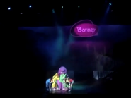 Everyone hugging Barney on stage.