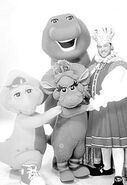 B&W promotional photo of Barney, Baby Bop, and BJ with the King