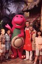 Barney, Professor Tinkerputt and a cast of children pose for a photo to promote Imagination Island.