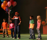 The Balloon Man talking with the kids.