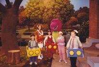 Barney and the cast of children with choreographer Penny Wilson.