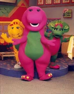 Promotional shot of Barney, Baby Bop, and BJ in the classroom.