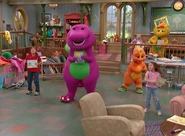 Barney and his friends holding books in their hands.