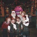 (Left to right) Kelly Eichenholz, Steve Jones (Santa Claus), Adam Brown (Gilford), Barney, Jeff Ayers (Snowflake), Bob Singleton, Sloan Coleman, and Oscar (Kyle Nelson) on the set of Santa's Workshop from this episode "A Visit to Santa".