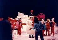 Barney, the Snowman, and the kids on set with a Barney & The Backyard Gang crew member.