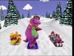 Barney, BJ, and the children go sledding down a hill covered in snow.
