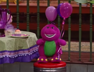 The Barney doll at the episode's conclusion with purple balloons.