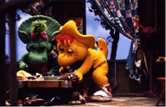 BJ and Baby Bop dig through a chest full of shoes.