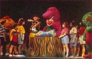 Barney showing everyone the heart that the kids made, taken from the back cover of the UK release.
