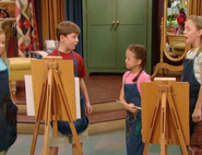 Kids wearing painting aprons