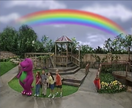 Barney and his friends beneath a rainbow (from the episode, "Spring Into Fun!").