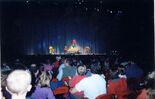 Barney, Baby Bop, BJ and the children sailing in a boat on stage.