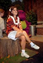 Penny Wilson sitting on the tree stump on set.