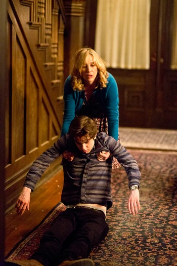 Meanwhile, Norma has her hands full dragging the unconscious Norman out of the house.