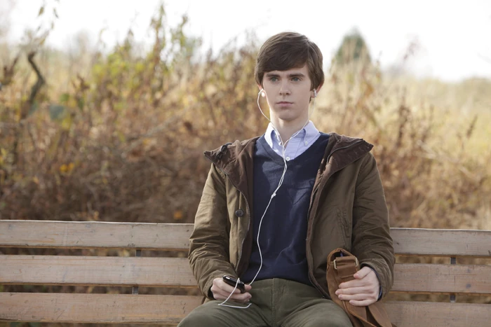 It's Norman's first day of school in his new home. He waits at the bus stop just outside the motel.
