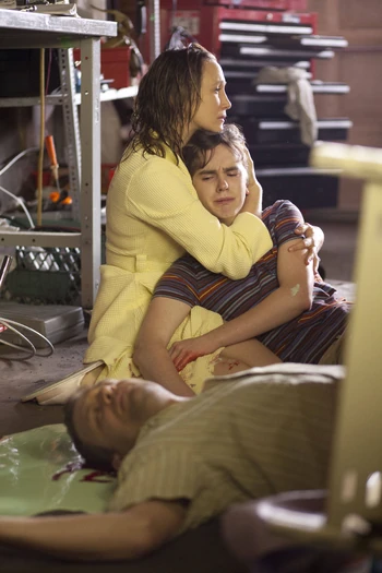 Norman tries to lift the heavy shelves off of his father, but he soon realizes he's too late. His mother, Norma (Vera Farmiga), comforts him as it begins to sink in that Sam is dead.