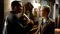 08-romero-shows-norma-a-search-warrant.jpg