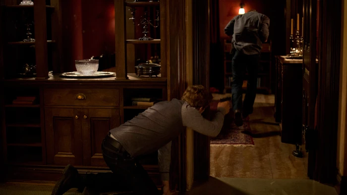 Shelby's gun is knocked to the floor as he fights with Norman. He subdues the boy, but Dylan manages to grab the weapon. The deputy notices and makes a run for it, narrowly avoiding Dylan's wild shots. Shelby grabs some cover and returns fire.