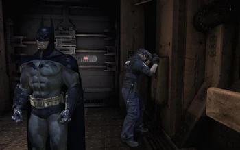 Eddie Burlow trying to get the fuse box to the Decontamination Chamber door open while Batman has his back turned.