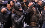 Bane-Batman in a headlock