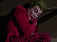 Joker having an frightfully unpleasant time on the Batpoles