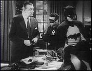 Batman and Robin with Commissioner Gordon.