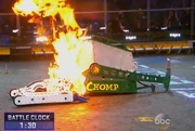 Chomp uses its flamethrower to roast a struggling Bite Force.
