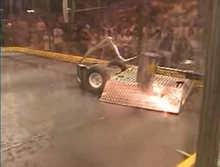 Evil Eagle is lifted into the pulverizer by Defenestrator.